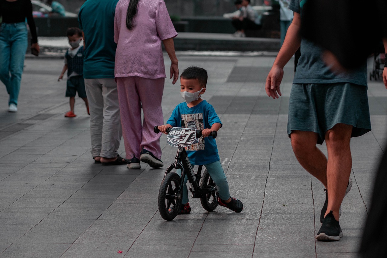 in focus, a child being taught children pedestrian safety by an adult