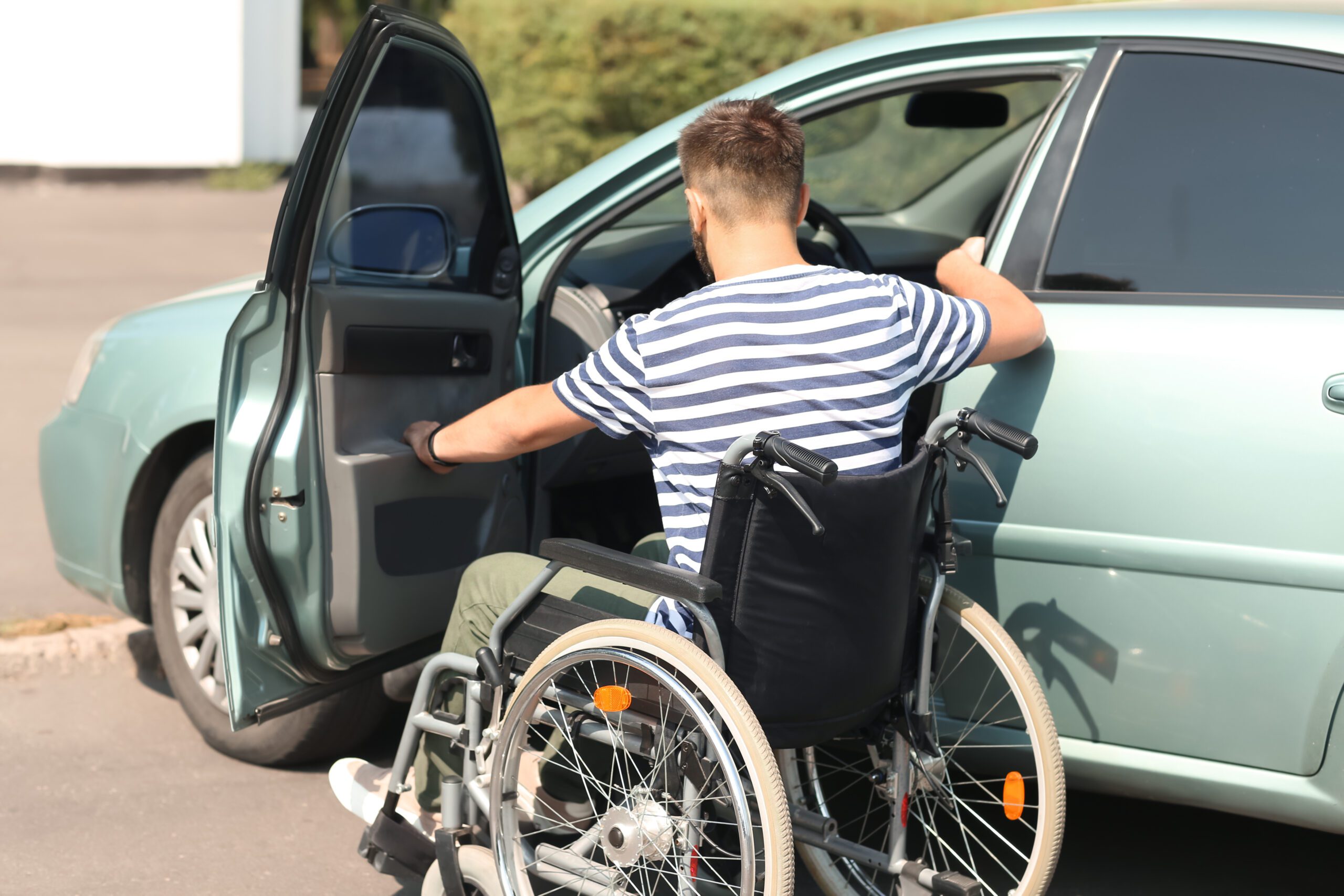 white and presumably paraplegic man about be driving with sci