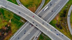 An aerial view of a highway intersection. Learn about the difference between a freeway and a highway (2025).
