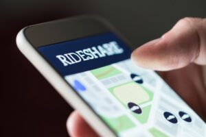 A phone with a rideshare app on it. A Beverly Hills Uber accident injury lawyer can guide you through the legal process and may make your financial recovery easier after a rideshare accident.