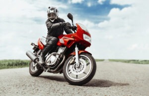 A helmeted motorcyclist poses on the road. A Palmdale motorcycle accident lawyer can help protect your rights after a crash.