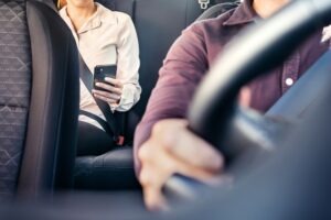 A woman taking a ride from a Lyft driver. You can build a claim after a crash with a San Diego Lyft accident lawyer.