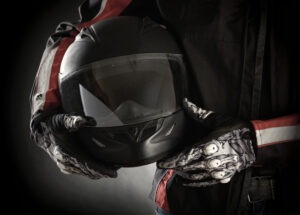 A San Jose motorcycle accident lawyer cradles a helmet under their arm.