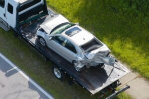 A car being towed away after a commercial truck accident, where the truck driver was liable.