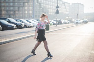 A woman jaywalking. Is jaywalking legal in California?