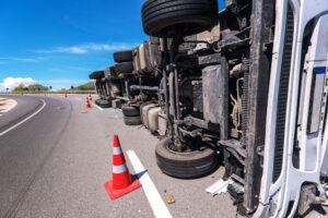 A semi truck tipped over on its side after crashing due to one of the main causes of truck accidents.