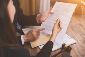 People review a legal document. How are wrongful death settlements paid out?