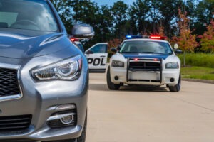 Police vehicles on a traffic stop, leaving a passenger to wonder, “What happens if my Uber driver gets pulled over?”
