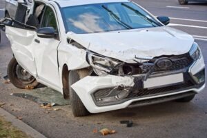 The frame damage to this white vehicle is considered major damage to a car.