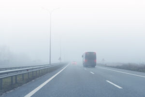 coach-bus-on-almost-empty-blue-foggy-misty-rainy-h-2025-01-10-11-05-25-utc