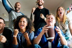 Friends watch the Super Bowl at a viewing party in California. If you drove from out of state for the game, an attorney can help you seek damages.