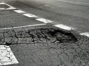 A pothole on asphalt on a dangerous road