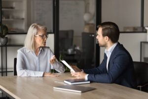 An older woman talks to her lawyer. A lawyer can help if you suspect abuse in a sub-acute care facility.