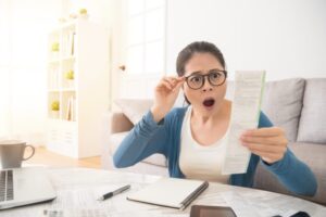 Woman surprised by expensive insurance bill after accident. Learn if your insurance will go up after an accident.